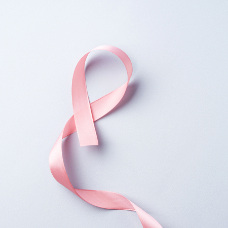 Breast cancer awareness pink ribbon symbol on gray background