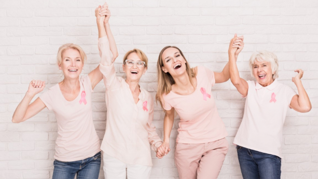 Group,Of,Smiling,Ladies,With,Pink,Ribbons,Cheering,And,Holding